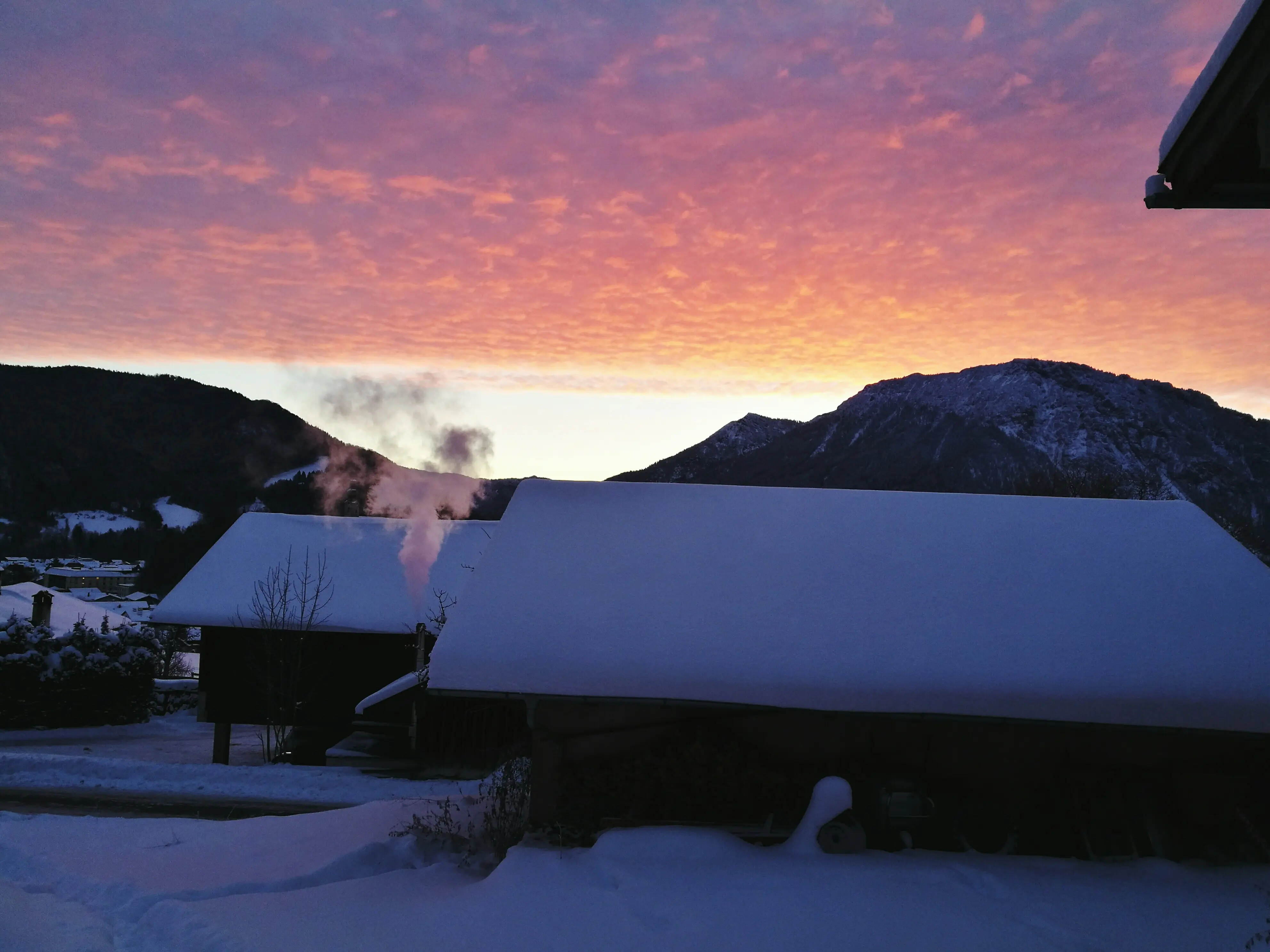 Picturesque view of snow-capped mountains against the sky at sunset.